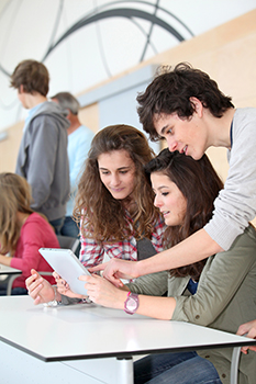 Group of teenagers in classroom with electronic tablet